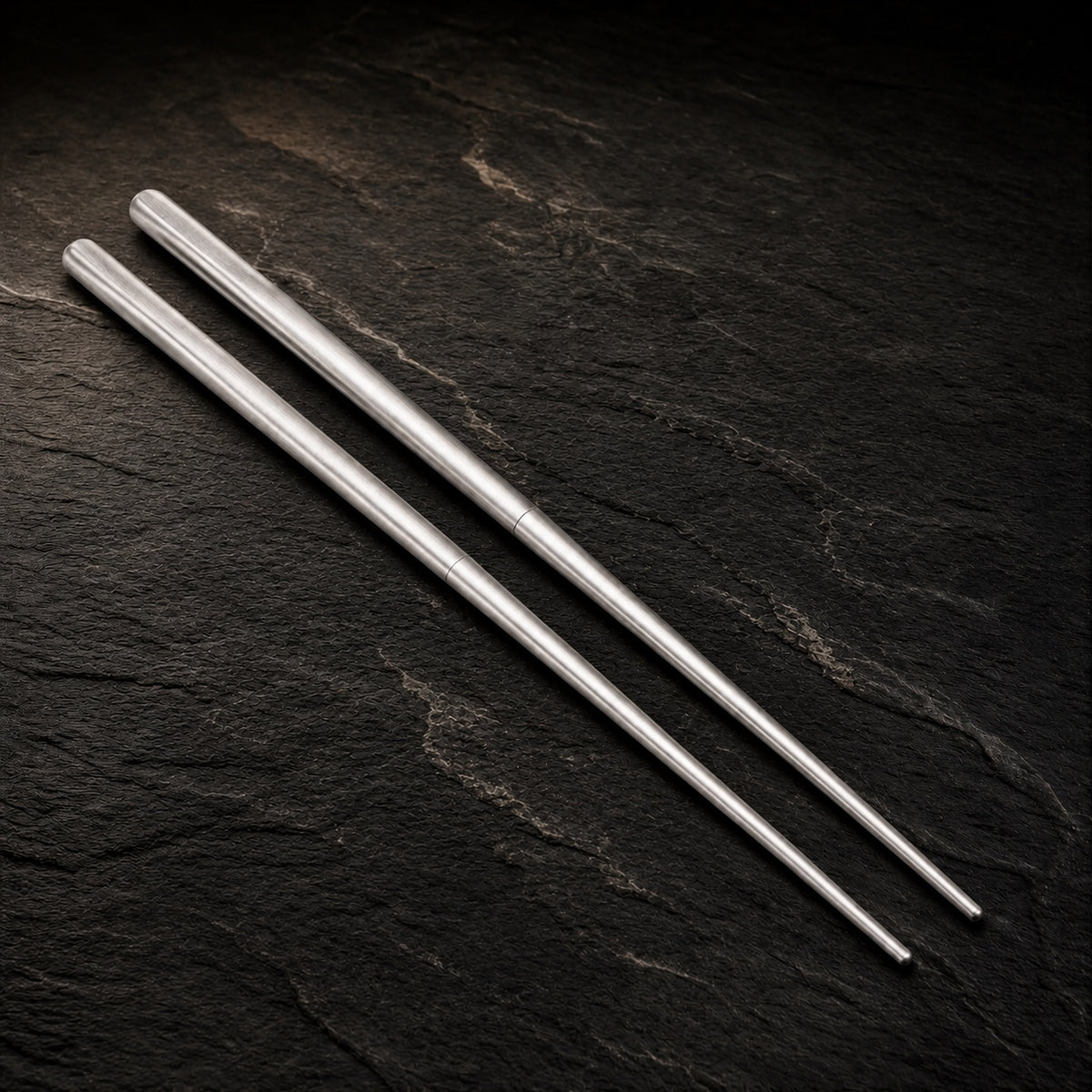 Titanium SafeCook Chopsticks (Set of 2) on a dark slate background