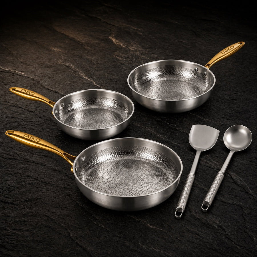 Signature Titanium Hammered Pro Cookware Set on a dark slate background