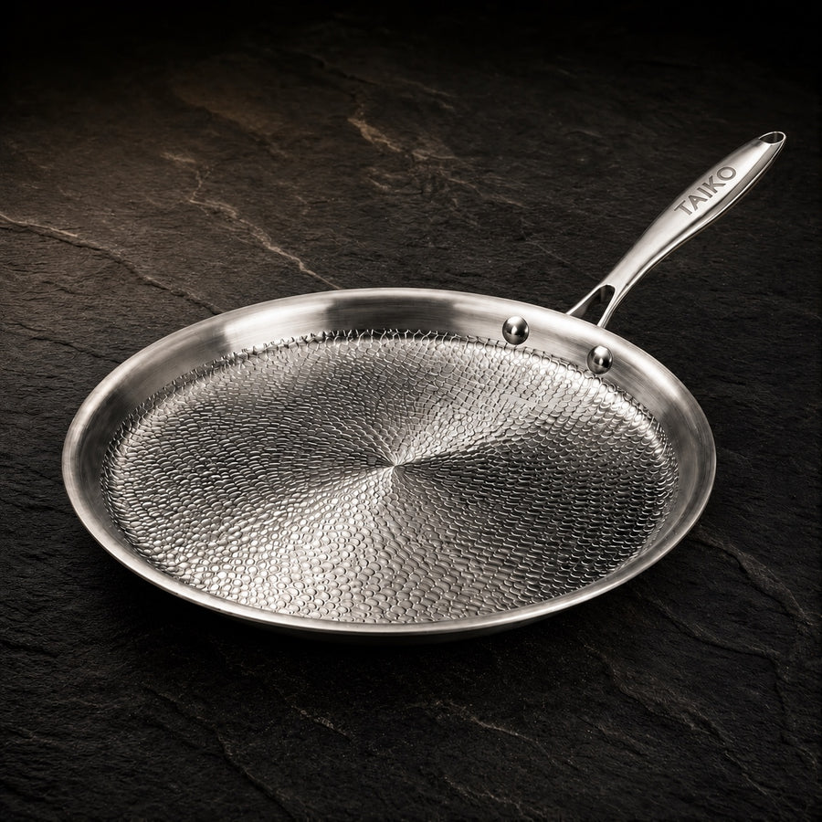 Premium Hand-Hammered Titanium Crêpe Pan on a dark slate background